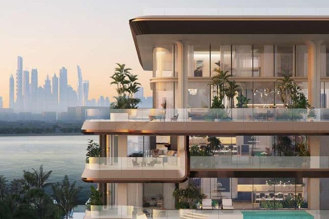 Modern multi-story building with glass balconies, lush greenery, and a city skyline in the background at sunset.