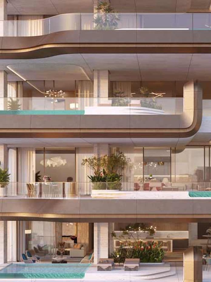 Modern luxury apartment building with large balconies, glass railings, and private pools overlooking a serene body of water at sunset.