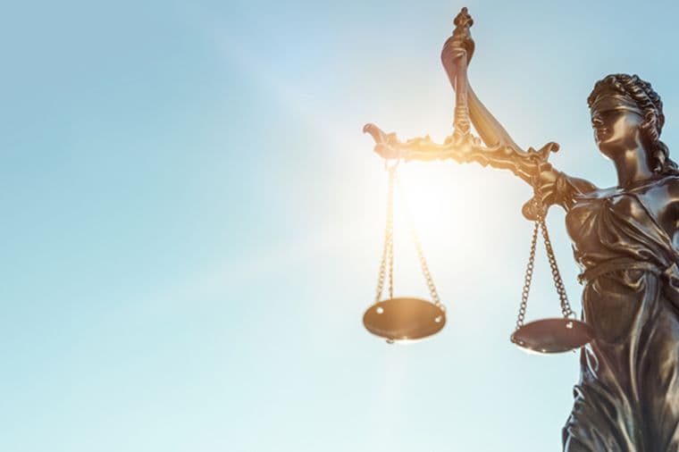 Statue of Justice on sky background