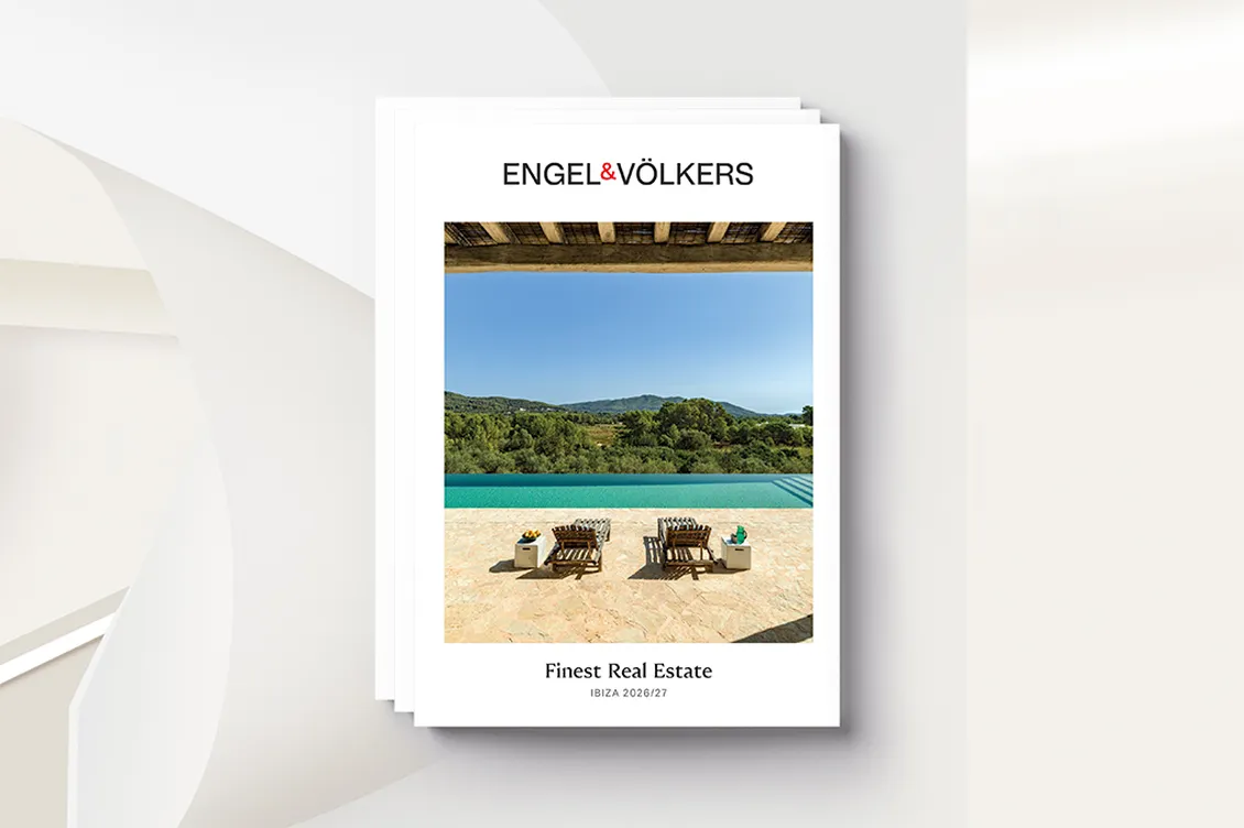 Stack of white real estate brochures with the Engel & Völkers logo, a poolside scene, and "Finest Real Estate Ibiza 2026/27".