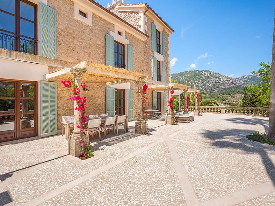 Elegant terrace with modern natural stone design, seamlessly integrated into a peaceful rustic setting surrounded by nature