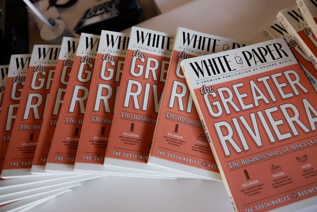 Copies of White Paper magazine displayed at the event, highlighting a feature on the Greater Riviera business landscape