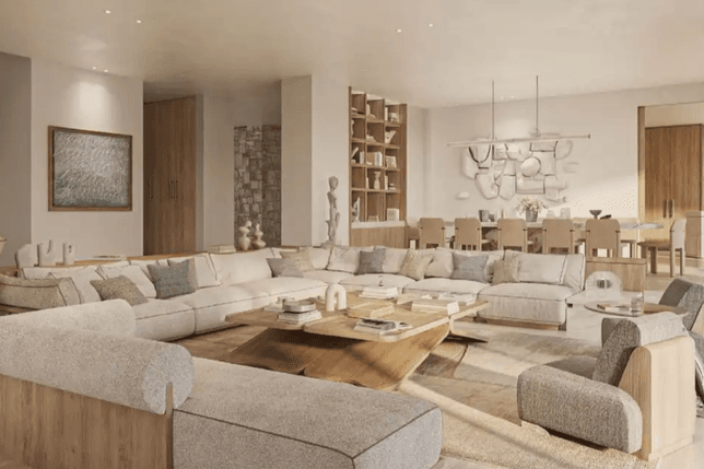 Spacious modern living room with beige sectional sofas, wooden coffee table, dining area, and abstract wall art in neutral tones.