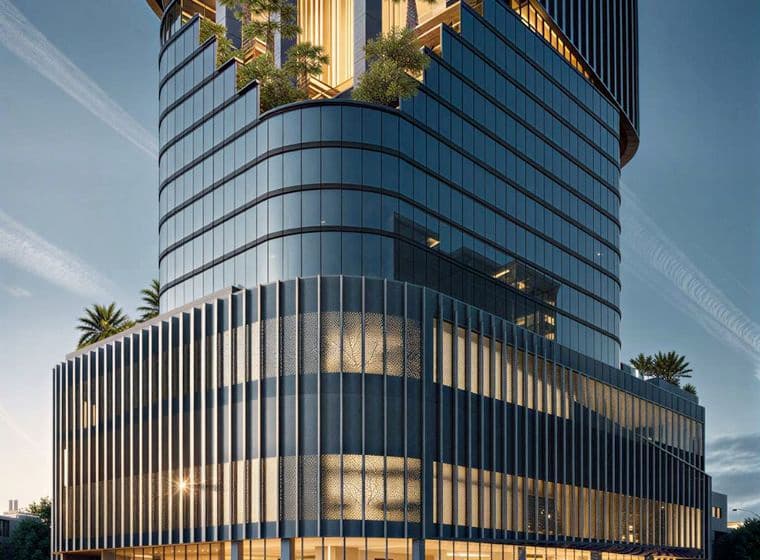 Modern glass building at dusk with illuminated windows, featuring tiered design and rooftop gardens with palm trees. Cars drive past softly lit street.