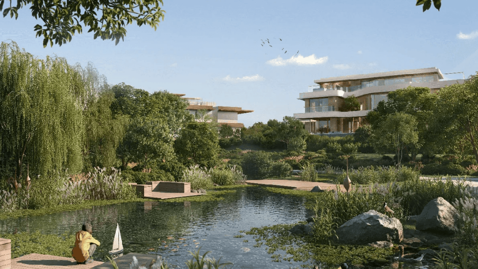 Serene landscape with a pond, ducks, lush greenery, and modern houses in the background under a clear blue sky.