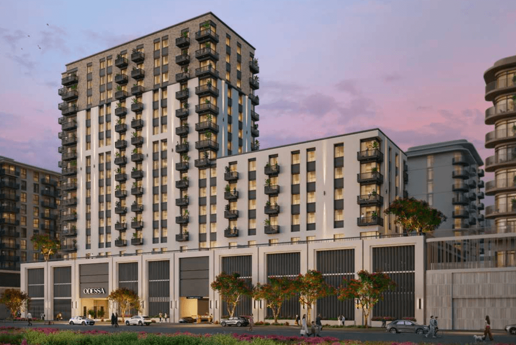 Exterior view of Odessa showing the mid rise residential buildings with balconies, ground floor retail, landscaped frontage, and evening lighting.