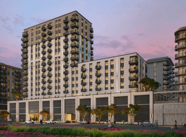 Exterior view of Odessa showing the mid rise residential buildings with balconies, ground floor retail, landscaped frontage, and evening lighting.