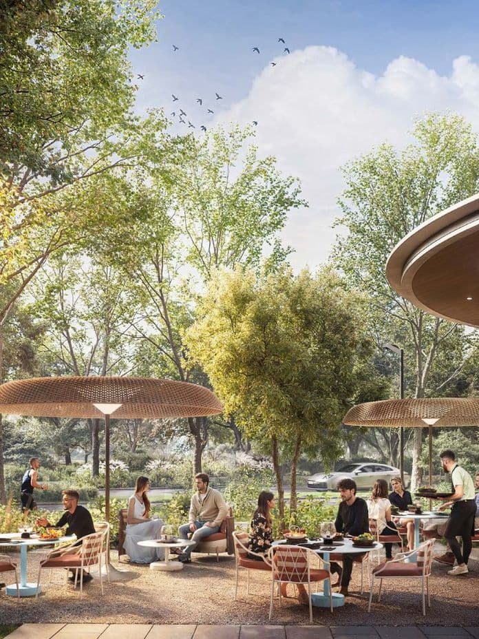 Belebtes Outdoor-Café inmitten üppiger Grünflächen von Ghaf Woods.