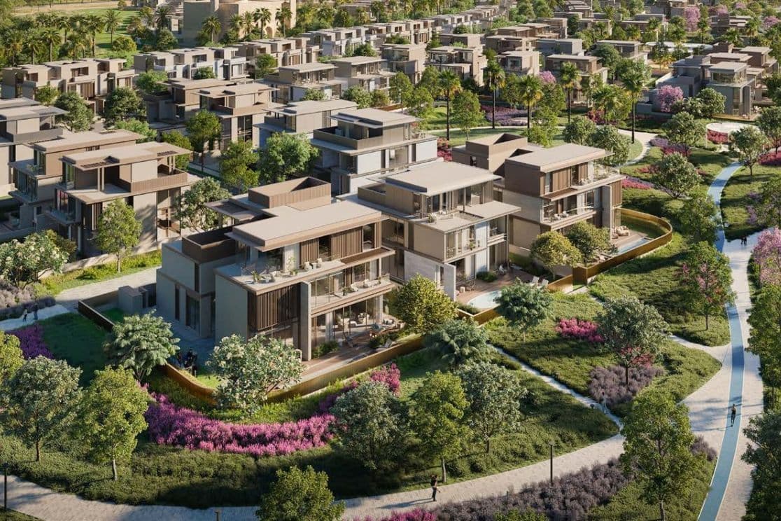 Aerial view of Nad Al Sheba Gardens Phase 10 by Meraas, highlighting modern villas, townhouses, and landscaped community pathways in a lush, green environment.