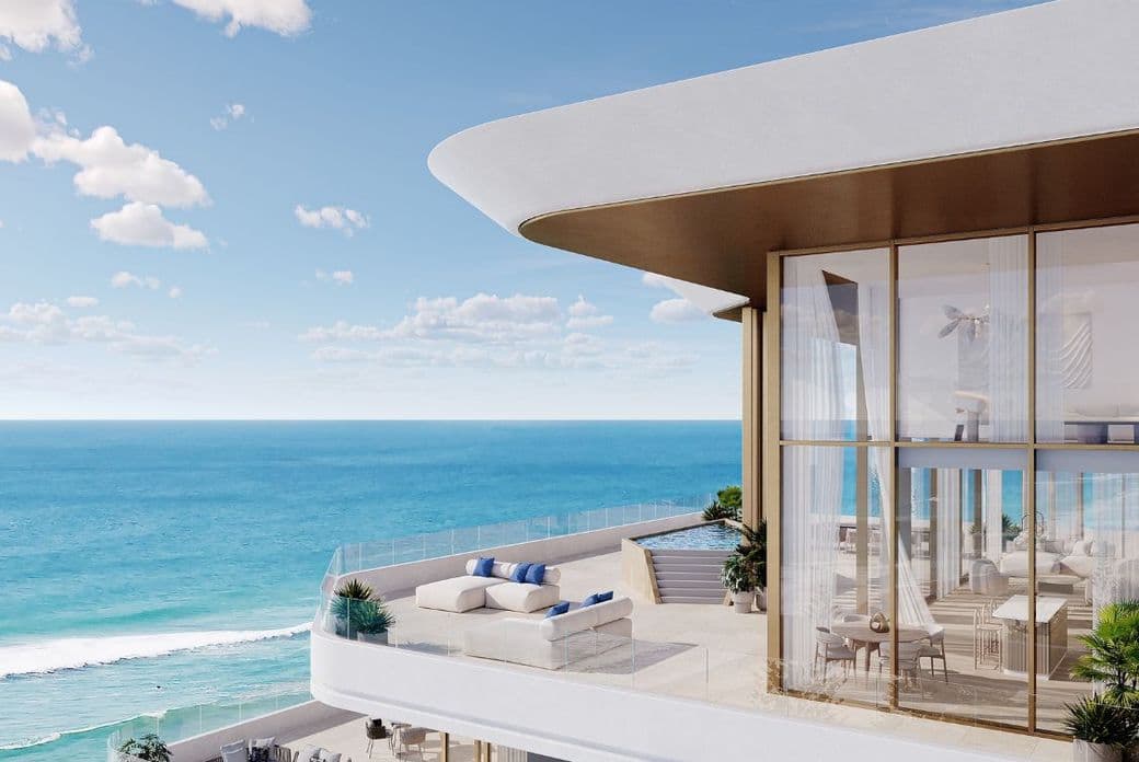 High-floor penthouse terrace at Nikki Beach Residences by Aldar in RAK with private lounge, glass balustrade, and sweeping ocean views.