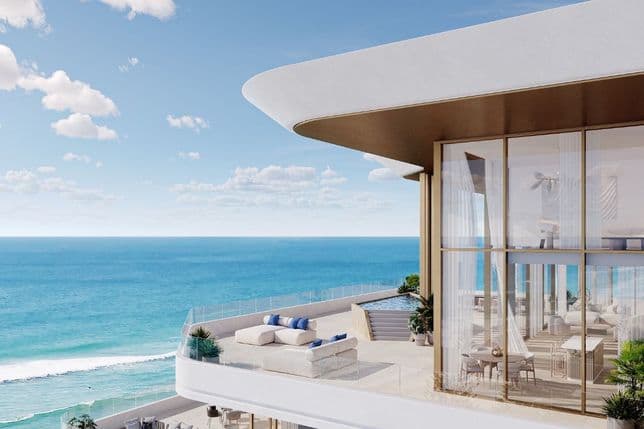 High-floor penthouse terrace at Nikki Beach Residences by Aldar in RAK with private lounge, glass balustrade, and sweeping ocean views.