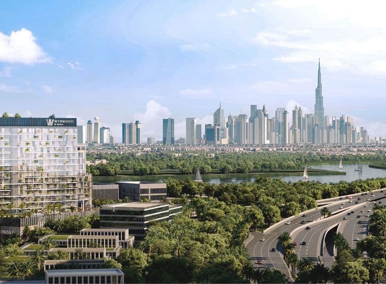 Modern mid-rise building labeled “Wynwood” with Burj Khalifa and Dubai skyline in the background.