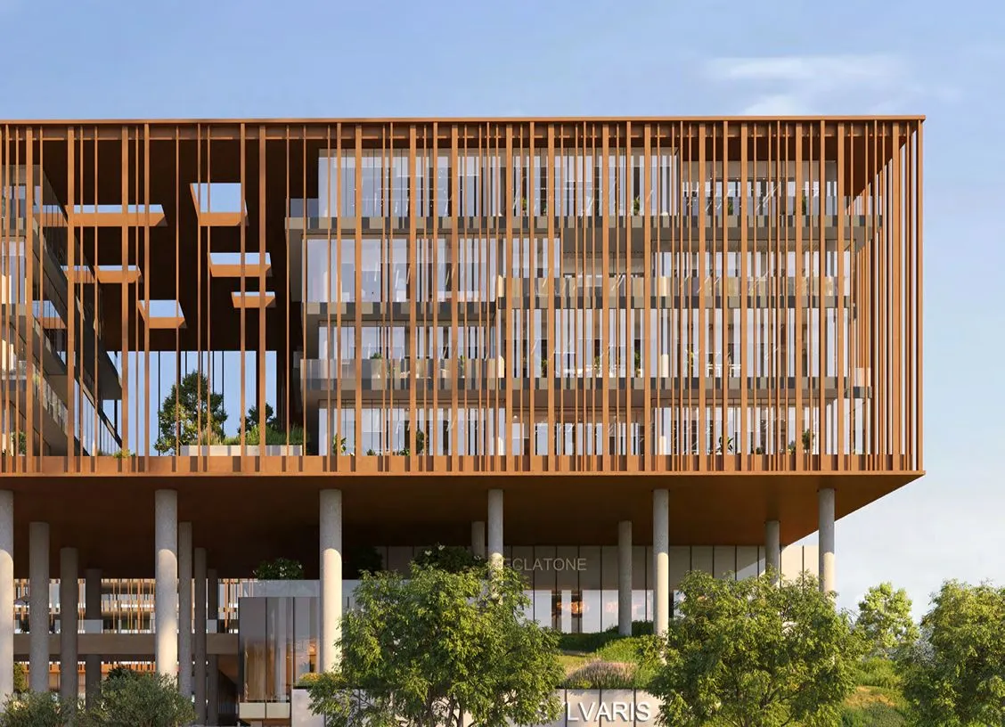 Modern office building with vertical wooden slats, glass walls, and tall concrete columns, elevated above greenery.