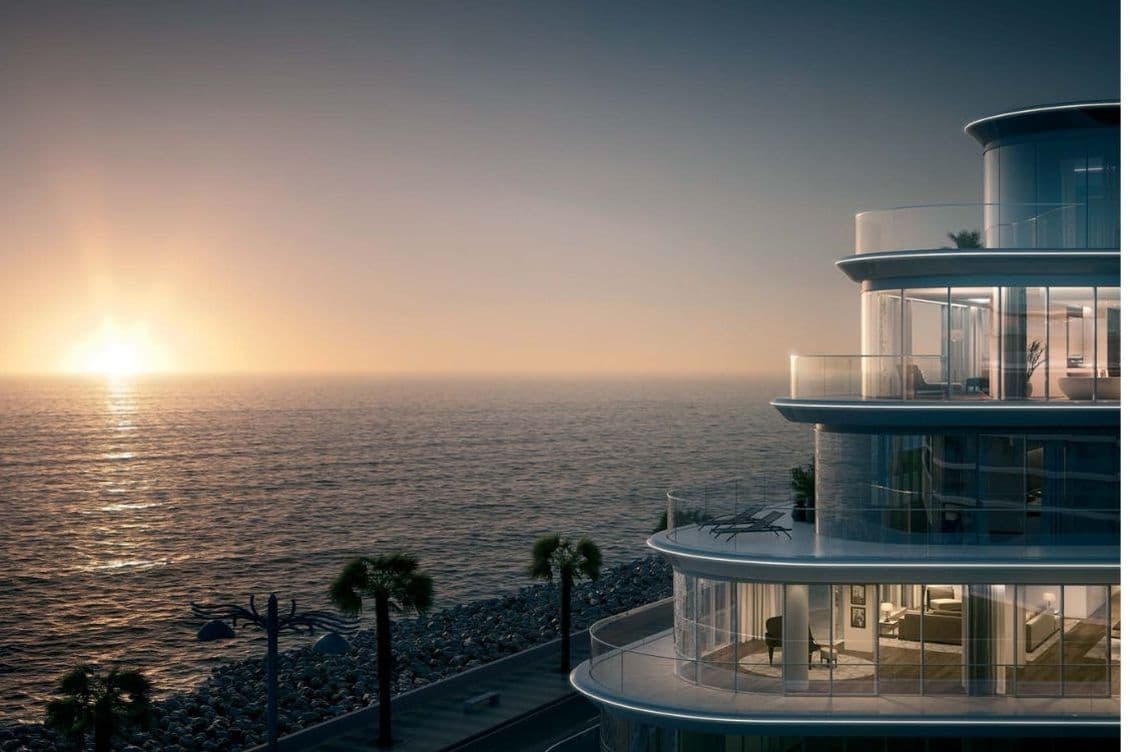 Sunrise over the Arabian Gulf from W Residences Dubai – The Palm with glass-wrapped curved balconies.