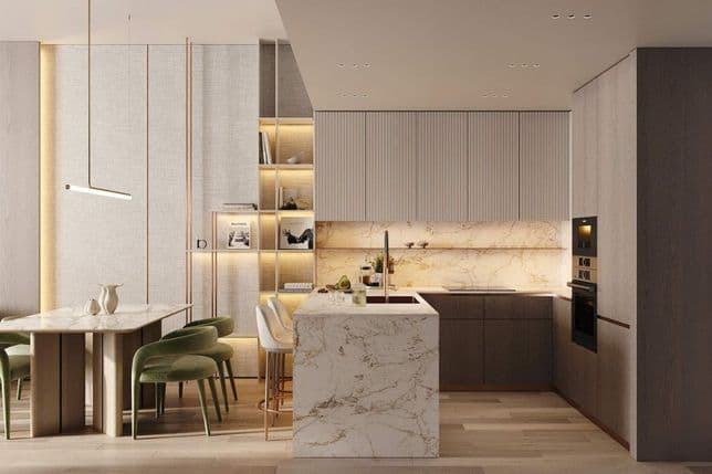 Open kitchen and dining area in Cove Edition 6 by Imtiaz Developers, featuring marble countertops, green dining chairs, and wooden cabinetry.