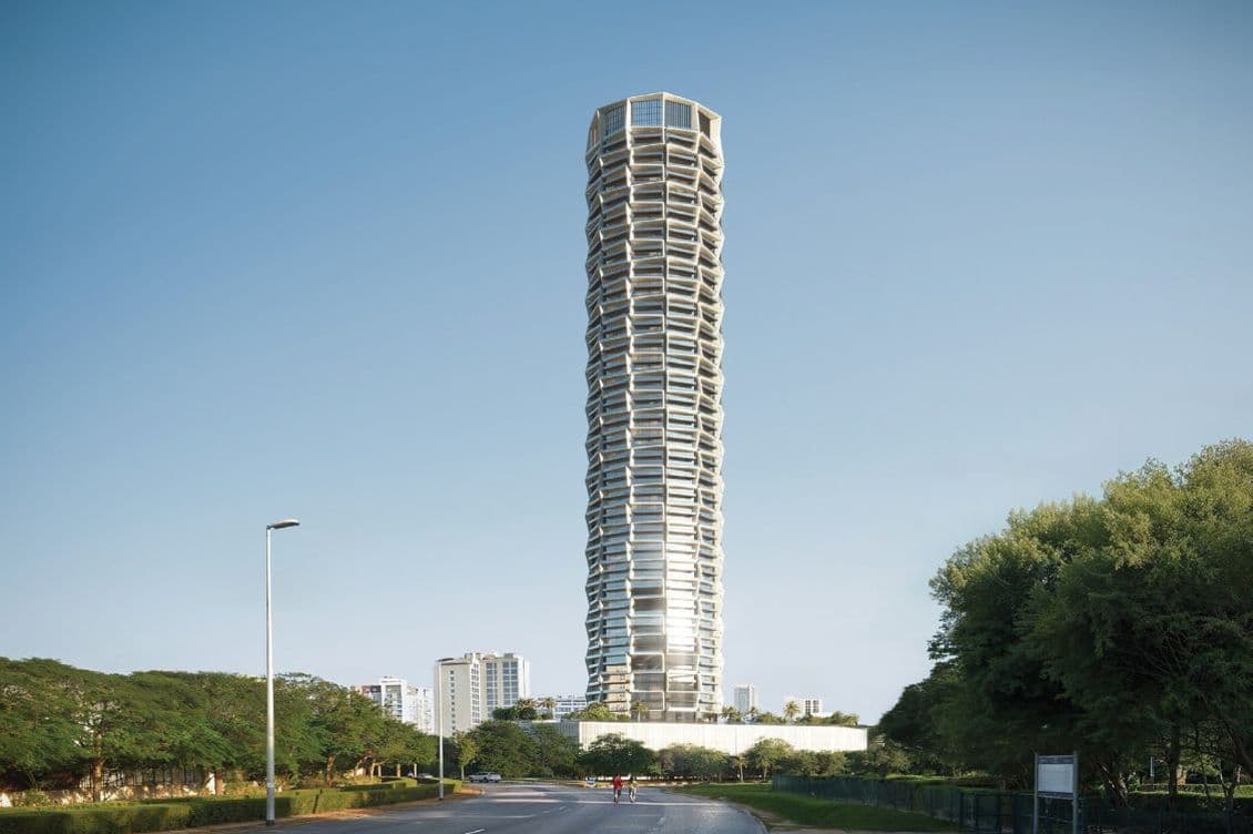 Street-level view of the Binghatti Circle skyscraper with its signature cylindrical shape and geometric façade in Jumeirah Village Circle, Dubai.