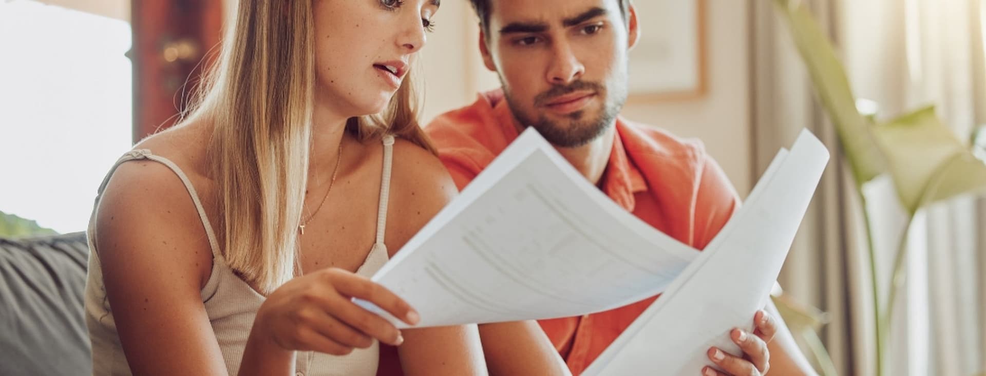 Couple looks at service charges bill in Dubai apartment