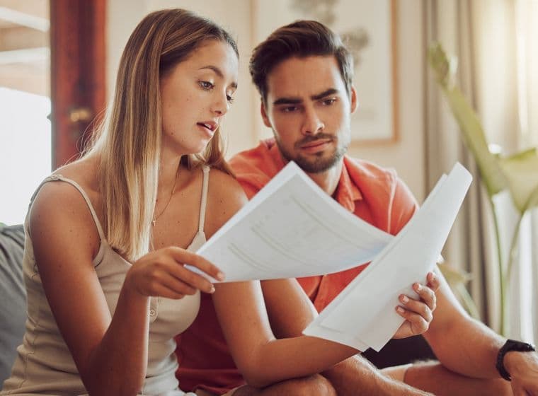 Couple looks at service charges bill in Dubai apartment