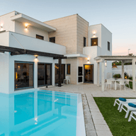 A contemporary villa with a beautifully landscaped garden and a private pool, illustrating the features to consider when buying the perfect villa in Dubai.