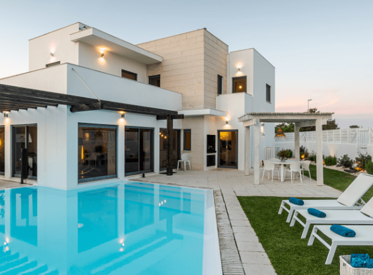A contemporary villa with a beautifully landscaped garden and a private pool, illustrating the features to consider when buying the perfect villa in Dubai.