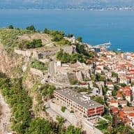Aerial view of Nafplio with historic fortress, coastal town, and panoramic sea views