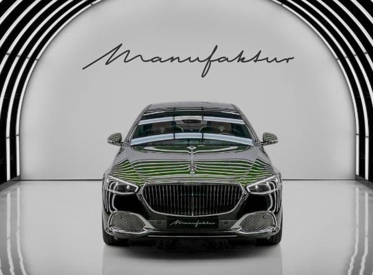 Luxury car in an elegant, illuminated tunnel with the word ‘Manufaktur’ written on the wall behind it. Vibrant lines of reflection emphasise its design.