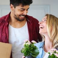 First time home buyers move boxes and plants into their new property