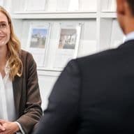Real estate agent discussing with a client in an office setting