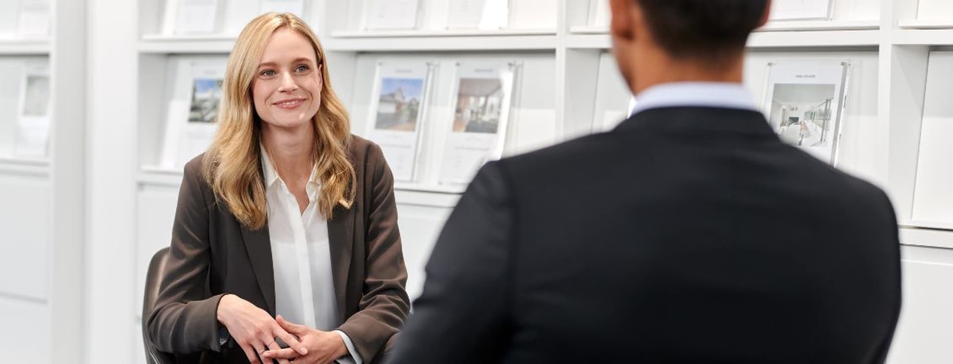 Real estate agent discussing with a client in an office setting