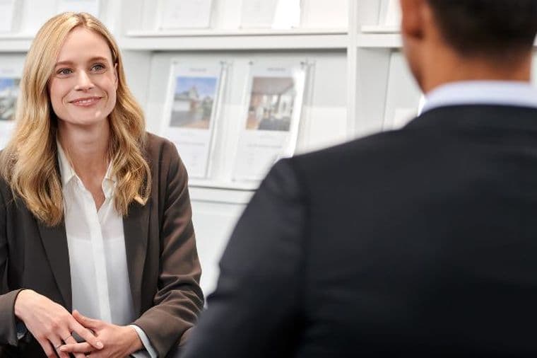 Real estate agent discussing with a client in an office setting