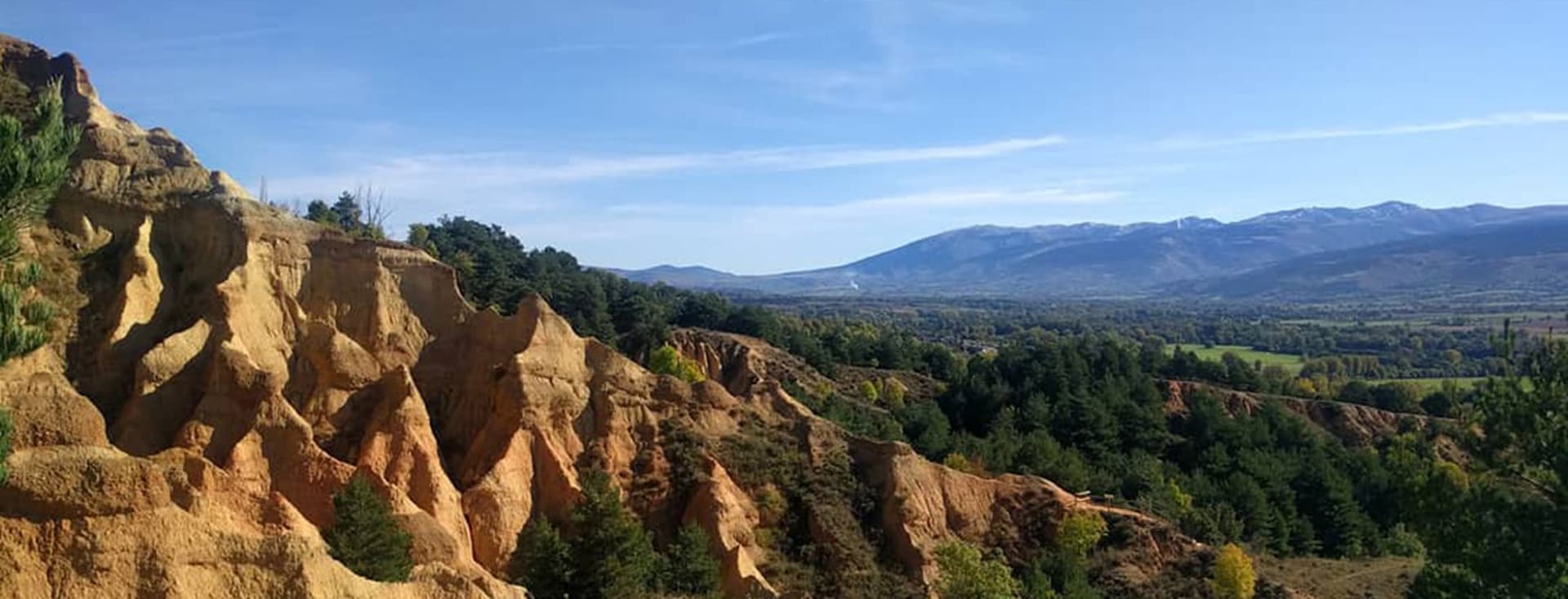 Badlands Olopte. Red eroded badlands with views of the mountains