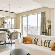 A well-furnished, open-plan apartment filled with natural light, symbolizing the ideal property to consider while navigating the laws and legal steps of buying an apartment in Dubai.