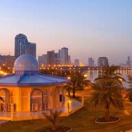 Mosque and waterfront in Sharjah at sunset