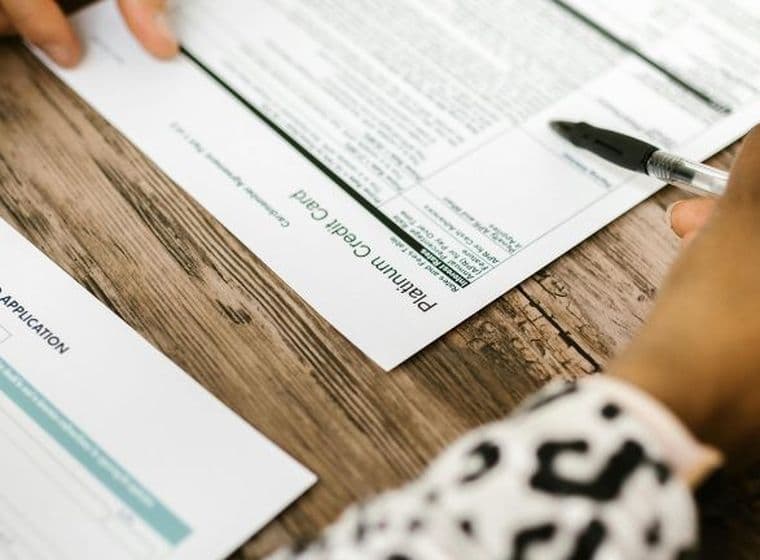 Person reviews paperwork regarding credit card application and security cheque