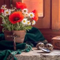 Rustic windowsill still life with red poppies, daisies, green cloth, and wooden music box in warm sunlight.
