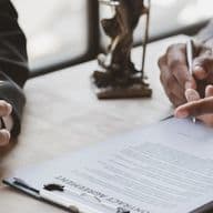 Man reads over Power of attorney document prior to signing