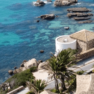 Costa de la Llum - vista al mar. Vil·les. Palmeres. Roques al mig del mar. Diferents colors turqueses a l'aigua