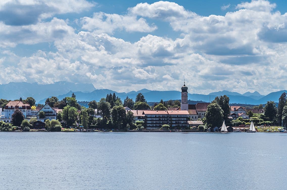 View of Seeshaupt at Lake Starnberg with church tower, sailing boats and the Alps in the background