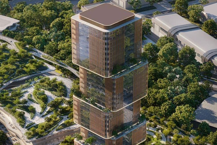 Aerial view of the 31 Above tower featuring its stacked glass architecture, warm vertical fins, and lush landscaped surroundings.