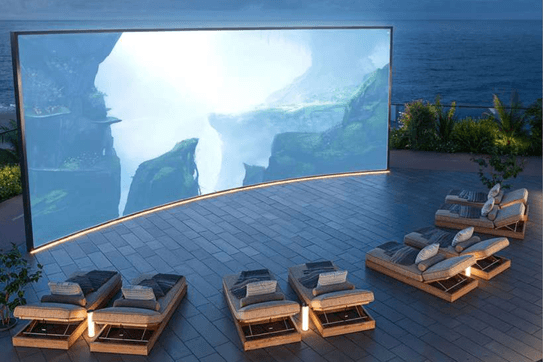 Outdoor cinema at ELLE Residences with landscaped seating and open air viewing area.