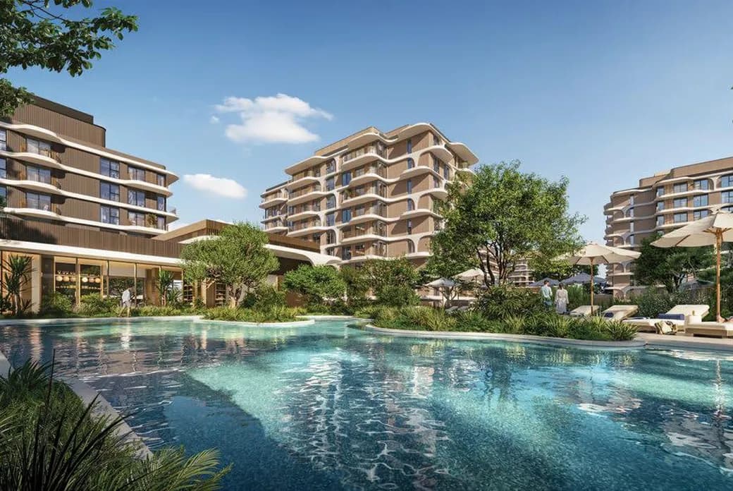 Modern resort with a large swimming pool, loungers and umbrellas, surrounded by multi-story beige buildings and lush greenery. AI-generated image