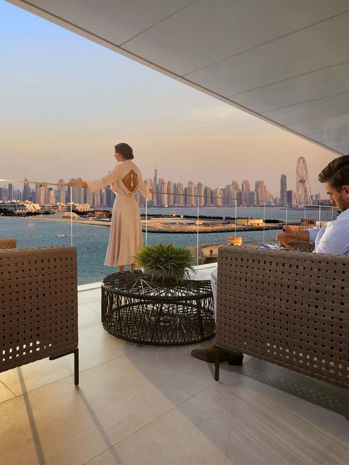 Private terrace at W Residences Dubai – The Palm with view of Palm Jumeirah and Dubai skyline.