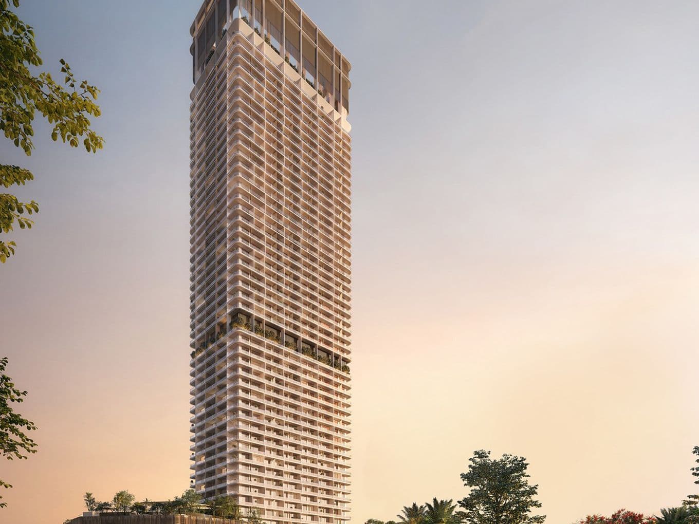 Exterior view of Marriott Residences JLT high-rise tower at sunset, with landscaped surroundings and street-level activity.