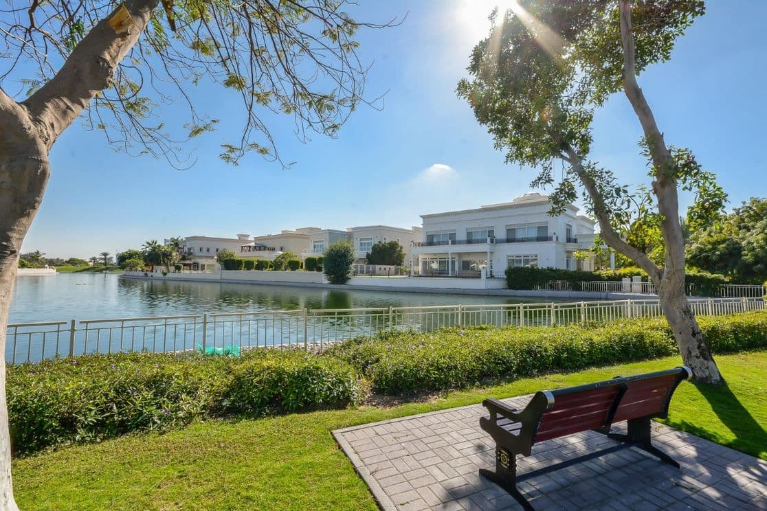 Die Parkbank blickt auf den malerischen See und die Villen in Emirates Hills