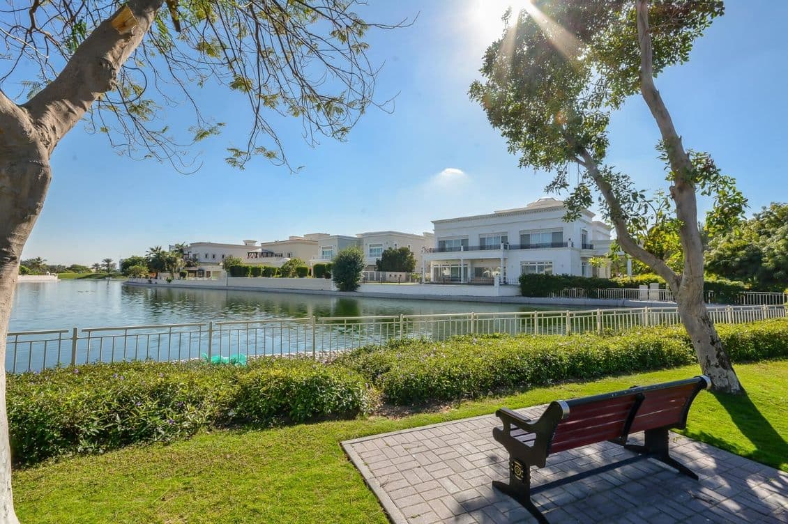 Bench overlooking lake and luxury villas in Emirates Hills