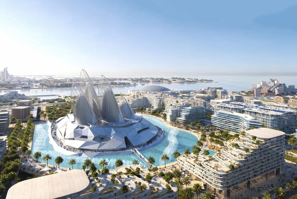 Futuristic waterfront cityscape with modern architecture, featuring a large dome, surrounding buildings, and palm trees under a clear blue sky.