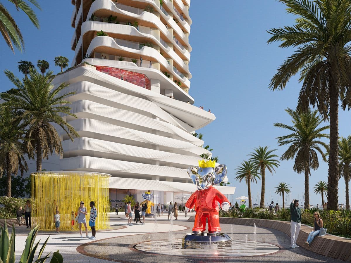 Modern building with wavy balconies, palm trees, and a colorful sculpture in a plaza with people and a water feature under a clear blue sky.