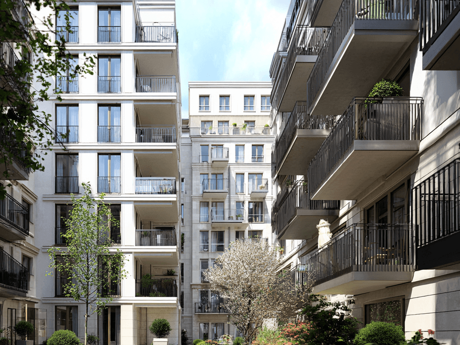 Berlin courtyard with apartment facades, balconies, and a few trees under soft daylight.