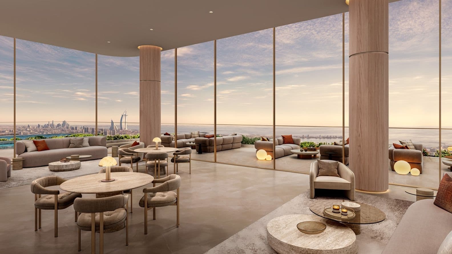 Luxurious lounge with elegant furniture and floor-to-ceiling windows offering a panoramic cityscape and ocean view at sunset.