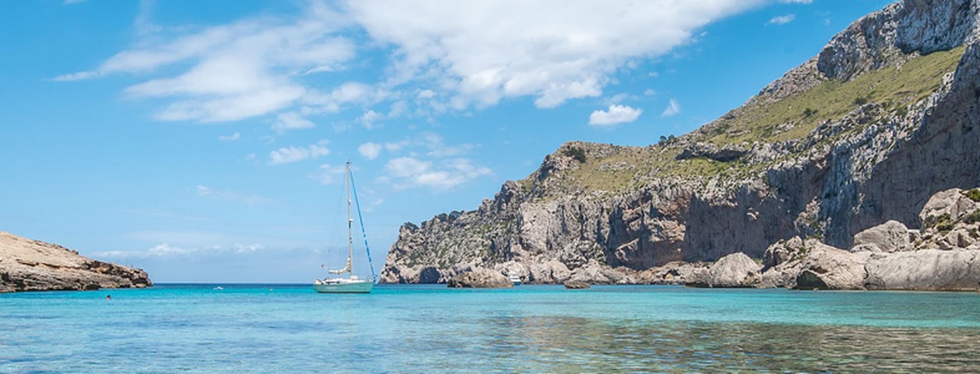 Vista al mar amb un veler solitari i penya-segats